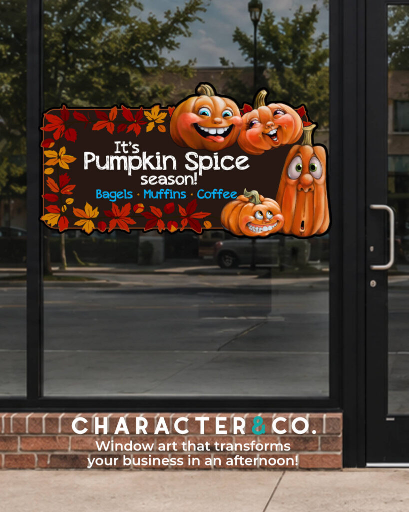 Custom pumpkin spice season window decal on a cafe storefront featuring cartoon smiling pumpkins, colorful autumn leaves, and text for bagels, muffins, and coffee by Character & Co.
